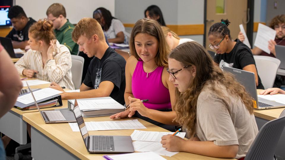 jccc classroom full of students working on papers and laptops