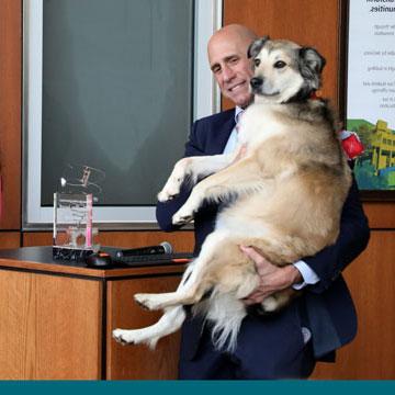 Gary Lezak and Sunny the Weather Dog at the Journalism department's Headline Award luncheon, after being presented the award by Journalism dept. chair Gretchen Thum