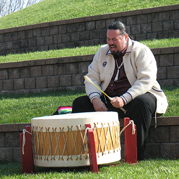 Ed Smith, Osage Nation citizen, playing a native drum in honor of fallen service members